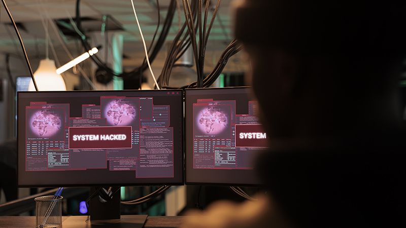 System hacked alert message on computer screen, hacker breaking into database server. Criminal cyberattack, malicious software, password cracking program, information stealing